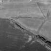 Oblique aerial view centred on the cropmarks of the enclosures  at Chapel Knap, looking to the NE.