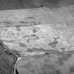 Oblique aerial view centred on the cropmarks of the square barrow, roundhouses, subrectangular buildings, ring ditch and pits at Kinchyle and Little Kildrummie, looking to the SW.