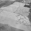 Oblique aerial view centred on the cropmarks of the square barrow, roundhouses, subrectangular buildings, ring ditch and pits at Kinchyle and Little Kildrummie, looking to the NNE.