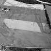Oblique aerial view centred on the cropmarks of the barrows and pits at Kinchyle and Easter Lochend, looking to the ESE.