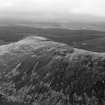 Oblique aerial view centred on the remains of the vitrified fort at Tap O' Noth, looking to the NW.