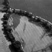 Oblique aerial view centred on the cropmarks of the possible enclosure and ring ditches at Haughs of Kinnaird, looking to the E.