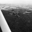 Oblique aerial view centred on the remains of the fort at Mither Tap of Bennachie, looking to the NNE.