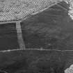 Oblique aerial view centred on the remains of a settlement, ring ditches and field system at Burn of Mannie, looking to to the E.