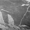 Oblique aerial view centred on the remains of a settlement, ring ditches and field system at Burn of Mannie, looking to to the N.