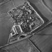 Oblique aerial view centred on the works and the remains of the field boundary, taken from the E.