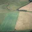 Oblique aerial view centred on the cropmarks of the Roman temporary camp, taken from the NW.