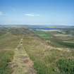 General view over Loch of Yarrows, taken from the Yarrows Archaeological Trail (c. ND 304 424). The farmstead is in the middle distance, beside the large tree.
Digital copy of photograph.