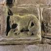 Detail of zoomorphic figure at bottom right hand corner of doorway on W side of tower.
