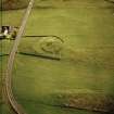 Oblique aerial view centred on the remains of the broch taken, from the WNW.