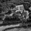 Oblique aerial view of house, gardens, stables and doocot from N.