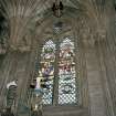 Thistle Chapel, interior, view of crests with stained glass window behind.