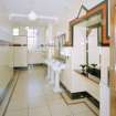 Interior.
Gentlemen's toilet, view from S showing original wash hand basins and 'Vitrolite' panels.