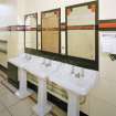 Interior.
Gentlemen's toilet, detail showing original wash hand basins, etched mirrors with shooting, diving and house designs, and 'Vitrolite' panels.