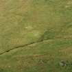 Oblique aerial view centred on the remains of the shieling mound, taken from the N.