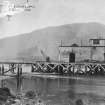 Scanned image of photograph showing pier head building including part of the pier and a small crane from NW.
Titled 'Jetty at Loch Long'.