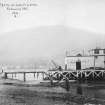 Scanned image of photograph of Arrochar Royal Navy Torpedo Testing Station and Range showing pier head building including part of the pier and a small crane from NW.
Titled 'Jetty at Loch Long'.
