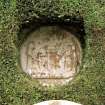 Detail of stone roundel set into wall of formal garden.