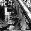 Scanned copy of view of boat being loaded with processed silica sand for transfer.