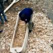 'Loch Doon' logboat experimental reconstruction (at Scottish Fisheries Museum, Anstruther): spring 1992. Reconstruction in progress: Damian Goodburn engaged in final axe-trimming, showing wood-chippings.
