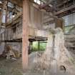 Interior. Pan House from 1950s. View of pan mill on right, worm feeder in background.