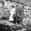 Copy of historic photograph showing portrait of crofters and cottage.