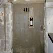Interior. West wing. Basement. Wine cellar door with bottle hatch. Detail
