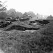 Digital copy of excavation photograph: SW wall and corner of chapel from E.