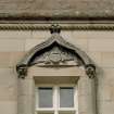 Detail of pediment above window on south front.
