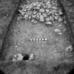 Digital copy of excavation photograph: unidentified trench with possible post or drain hole.