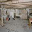 Interior. Ground floor. Main milling area (W part of structure). View from NW. showing double doors, flagstone floor and bottom of staircase to  first floor.