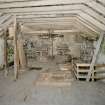 Interior. 1st floor. Main milling floor. View from S showing conveyor frame, grain elevator, stones and stairs.