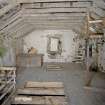 Interior. 1st floor. Main milling floor. View from NW showing grain cist, roof structure and grain conveyor frame.