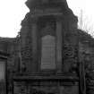 General view of Carstairs monument in wall of churchyard.