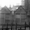 Detail of dormers with sculptured stones, with railings in foreground