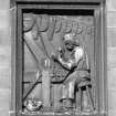 Edinburgh, 73-91 Holyrood Road.
Detail of panel showing figure working.