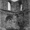 North east angle of cloister with East processional door & book presses
