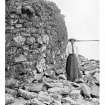 North Uist, Dun Torcuill.
View of broch wall along south edge. Women standing in view.
Photograph copied from 'North Uist' by Erskine Beveridge.