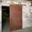 Interior. Second floor, E end from E. Detail of blast door by Mather and Platt of Manchester