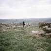 Copy of colour slide (H 93813sc) showing general view of recumbent stone circle. Mr Alan Leith (RCAHMS) in picture.