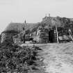Hougharry
View of blackhouses with man outside.