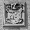 Detail of carved panel in E elevation representing coat of arms and motto 'Deum Time'.