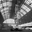 Ex-Scotland.  England, Earls Court and Olympia, British Industries Fair. 
Photographic view of exhibition hall showing stands under construction.
Insc on verso:  'B.I.F. under construction  Please return photograph to Mr Basil Spence 40 Moray Place Edinburgh.'