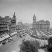 General view of Princes Street looking east towards Calton Hill from the Scott Monument showing Waverley Gardens, the North British Hotel and a busy street full of shoppers, trams and cars.