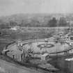 View of the Royal Patent Gymnasium in Royal Cresent Park, Edinburgh. It opened in 1865 but closed at the end of the century and was turned into a football ground. The circular device is a giant round boat allowing hundreds of people to row at the same time.