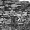View of interior of Dun an Ruigh Ruadh, showing Charles S T Calder surveying, drawing board on knee.