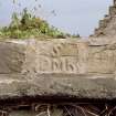 Blocked doorway on S wall, detail of carved stone panel above