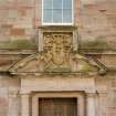 Courtyard, detail of pediment above doorway in centre of south wall
