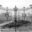 Historic photograph showing view of wrought iron gates.