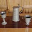 Interior.
Detail of Communion plate; pewter goblet, tankard and cup.